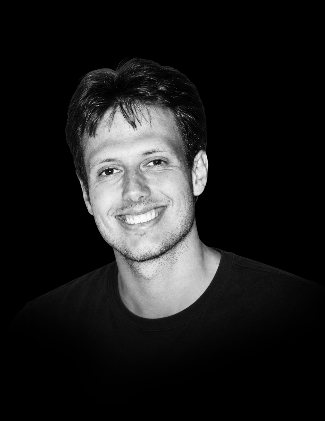 John Kayem smiling, in black and white